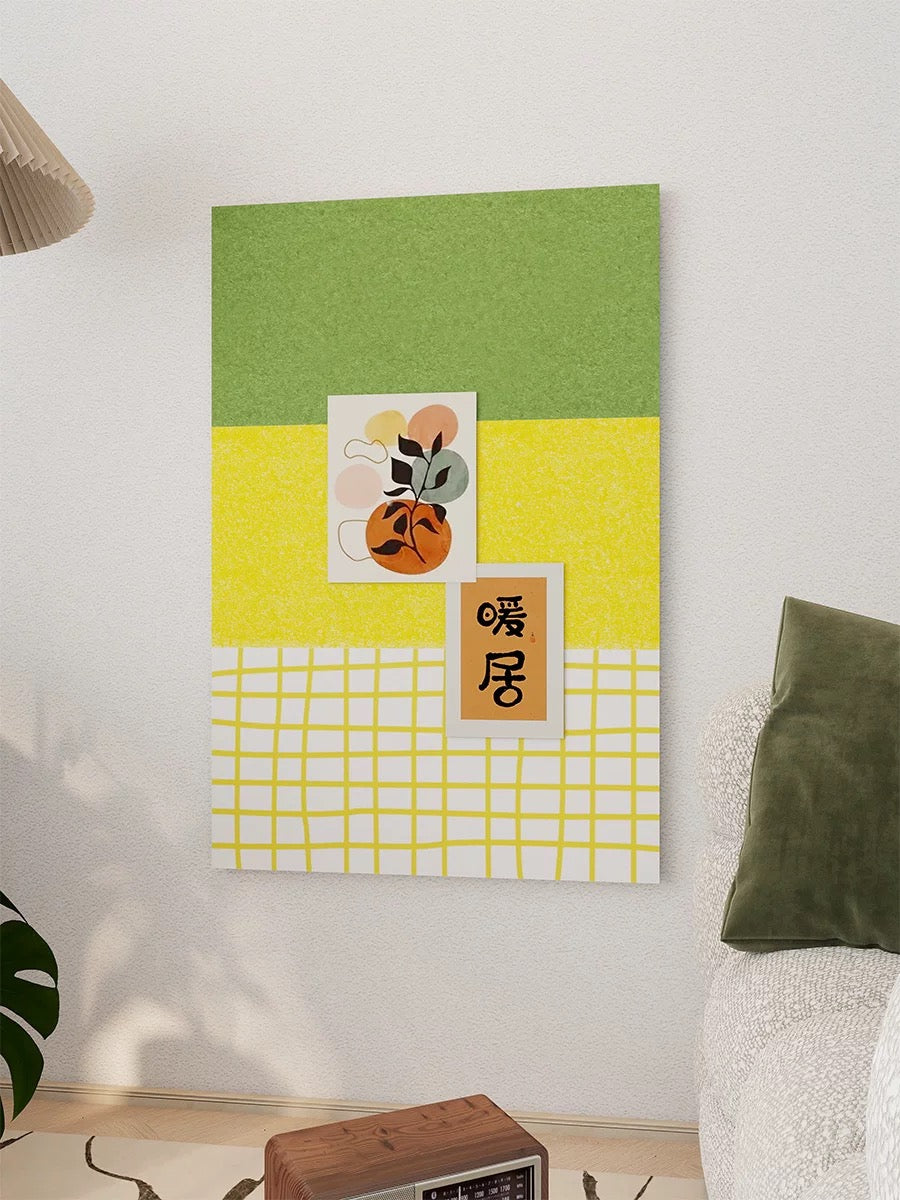 Yellow green felt pin board shown closer with pinned art above a small table