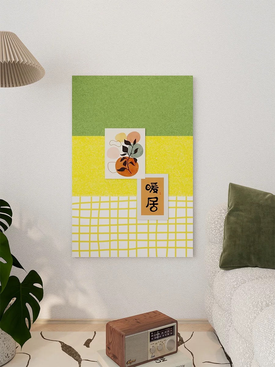 Yellow green checkered pin board with pinned art styled above a table beside a plant