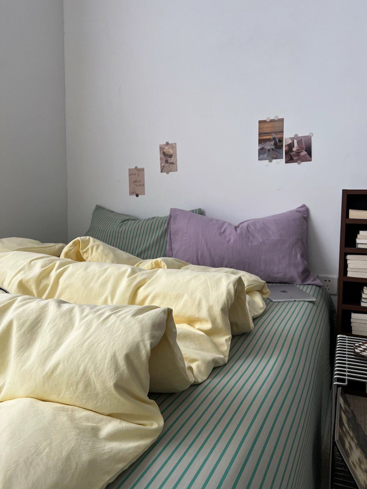 Yellow sage duvet cover set styled with lilac and sage accents on a low bed